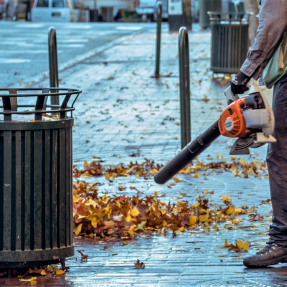 Person using gas powered leaf blower 